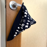 Bandana folded and hanging from a door handle